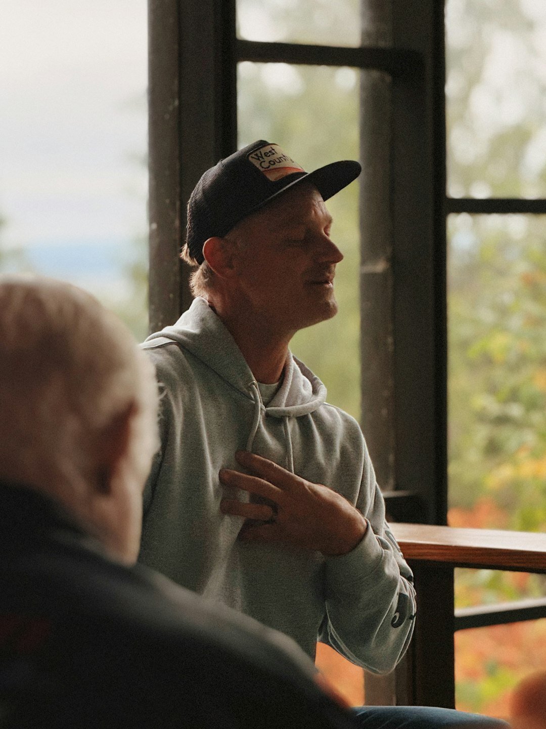 Mentor and mentee talking one on one near a window