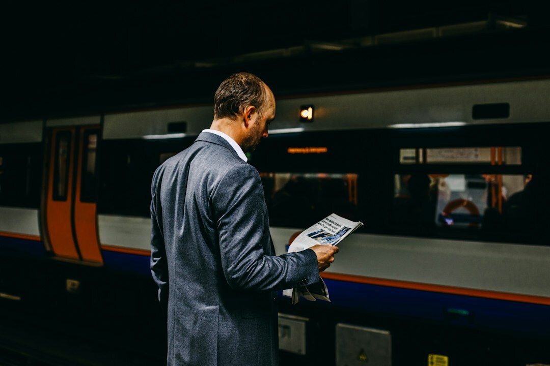 Male manager reviewing documents thoughtfully at his desk